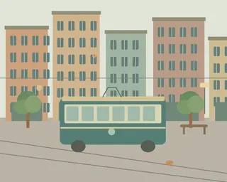 A green tram passing colorful old town buildings, window flowers, a street sign and a bench.